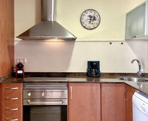 A kitchen with a stainless steel range hood, a coffee maker, and a wall clock. - CENTRIC APARTMENT with POOL in TOSSA 2 (Tossa de Mar)
