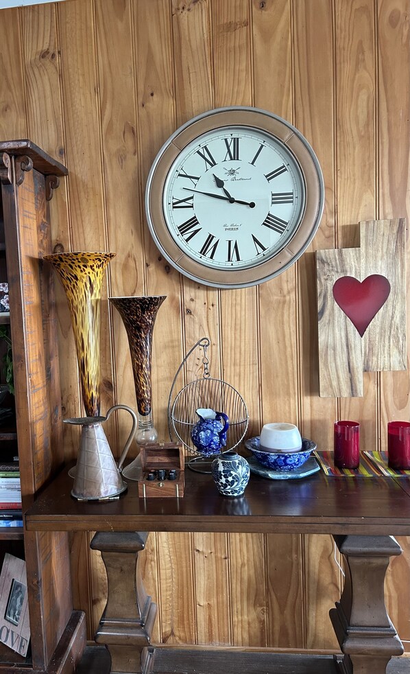 Timeless charm fills this inviting space, featuring a large wall clock and decorative accents.