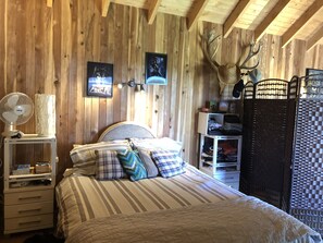 Cozy bedroom with a large bed, nightstand, and wardrobe for a comfortable stay.