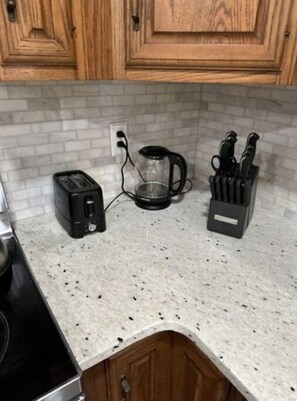Enjoy cooking in this well-equipped kitchen with a toaster, coffee maker, and knife block.