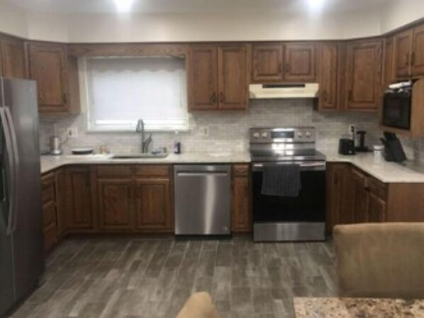 Enjoy cooking in this well-equipped kitchen with an oven, microwave, and dishwasher.