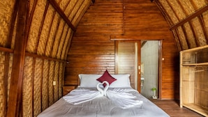 A wooden room with a high ceiling and a bed with a heart-shaped pillow arrangement. - KINTAMANI Paradise 4BR (Kintamani)