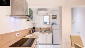 A compact kitchen with a stove, sink, and cabinets. - Mesmerising Views for a 2BR APT in the Capital ! (Valletta)