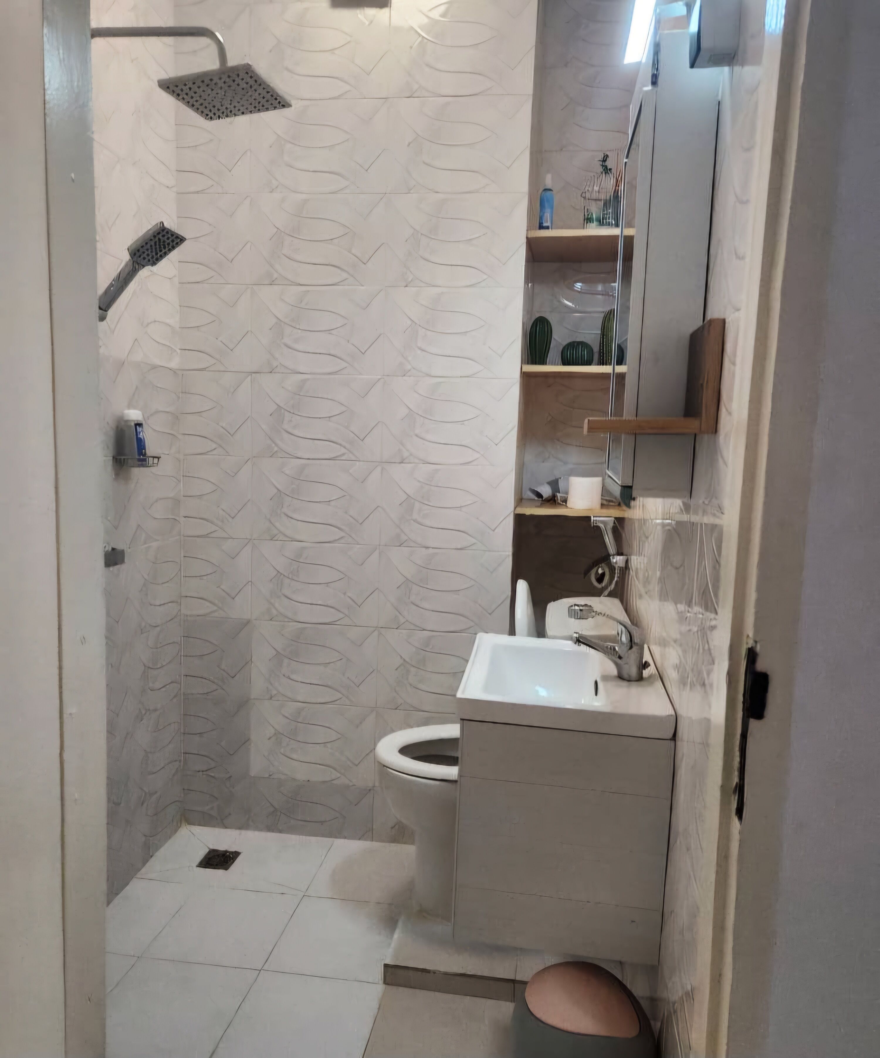 A bathroom with a shower, toilet, and sink.