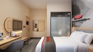 A hotel room with a bed, a desk, a chair, a television, and a painting on the wall. - Ivy Hotel Addis Ababa (Addis Ababa)