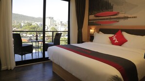 A hotel room with a large bed, a balcony with a table and chairs, and a city view. - Ivy Hotel Addis Ababa (Addis Ababa)