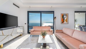 A modern living room with a large TV, a sofa, a coffee table, and a view of the sea. - Villa Sagnia, 4 en-suite bedrooms, sea views (Makarska)