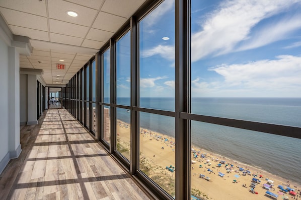 Enjoy the ocean view from this corridor with large windows overlooking the beach.