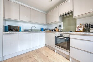 Enjoy cooking in this well-equipped kitchen with a Bosch oven, microwave, and ample countertop space.