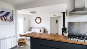 A modern kitchen with a wooden countertop, black cabinets, and a stainless steel range hood. - New house ideally located in Les Sables d'Olonne (Les Sables-d´Olonne)