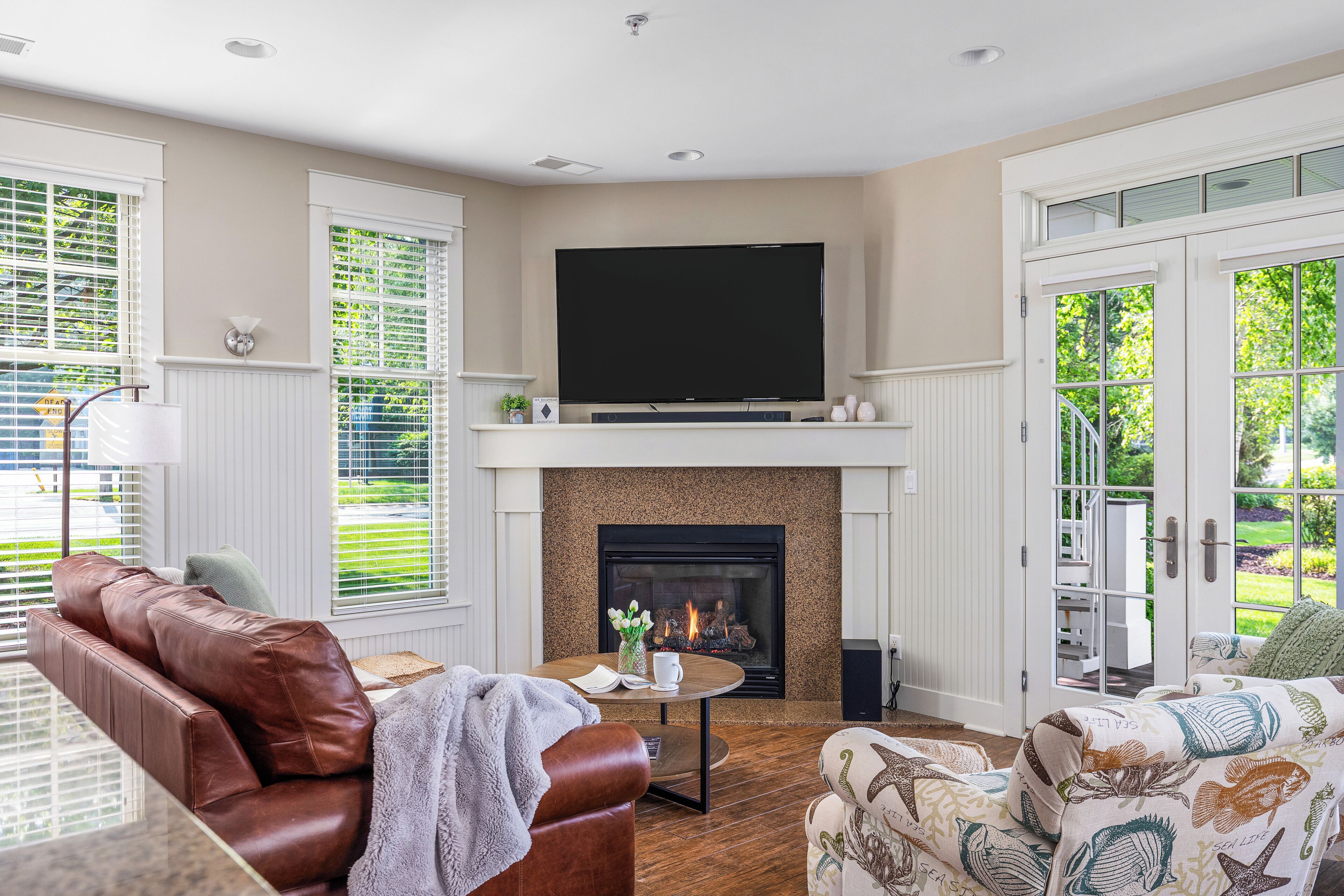 A living room with a fireplace, a television, and comfortable seating.