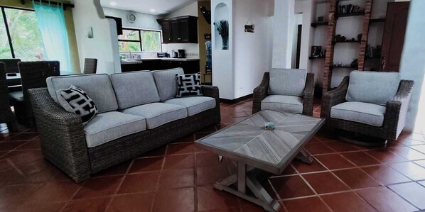 A living room with a sofa, two armchairs, and a coffee table.