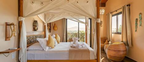 A wooden four-poster bed with a canopy, a large vase, and a wooden floor.