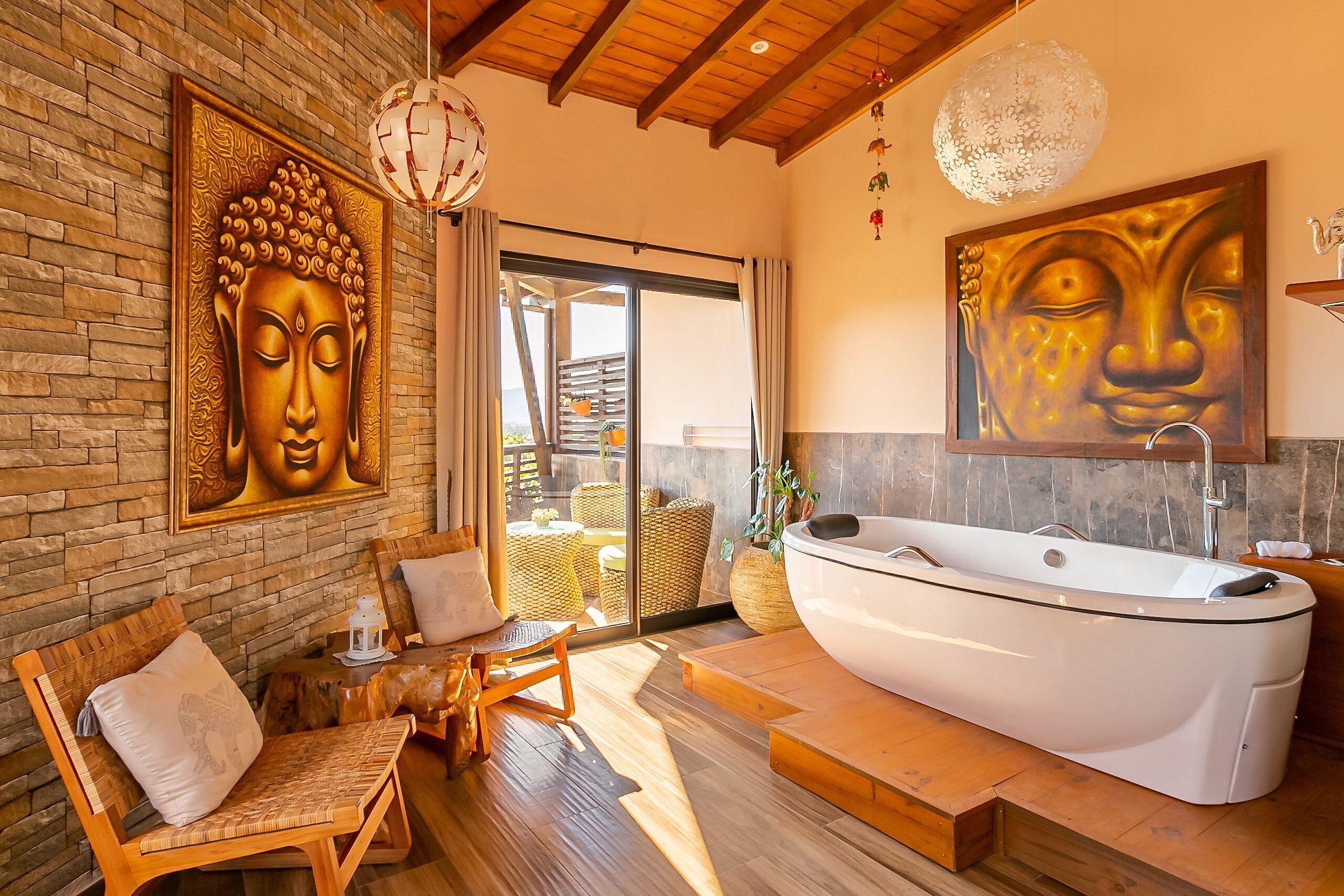 A modern bathroom with a large bathtub, wooden flooring, and a stone wall.