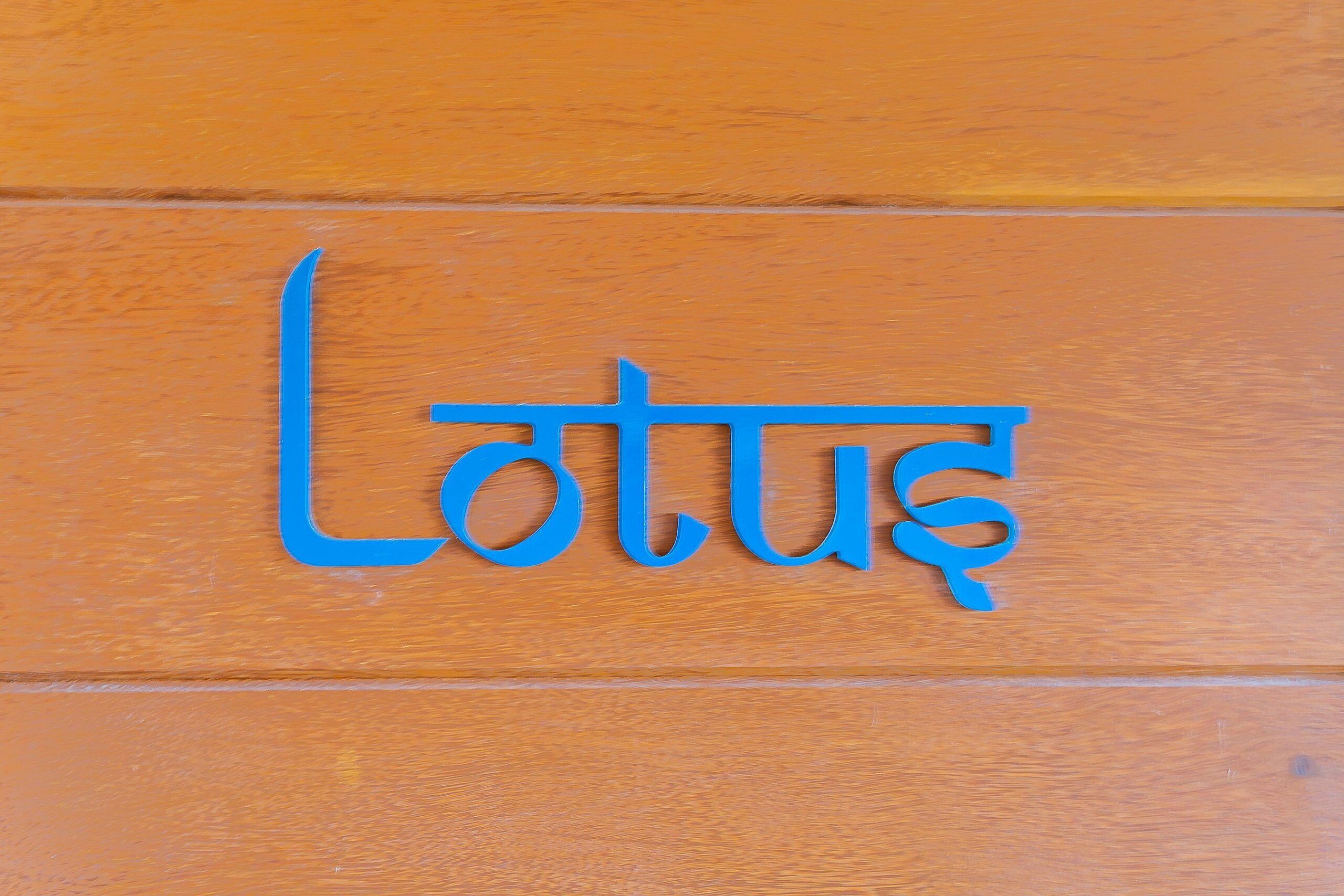 A wooden panel with blue text.