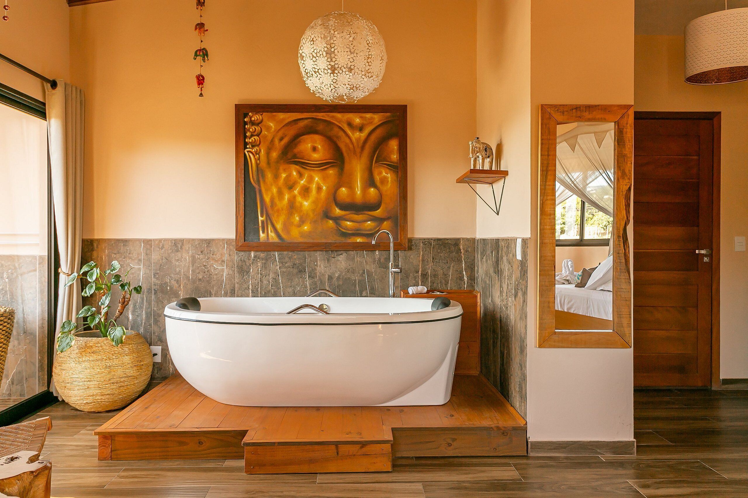 A modern bathroom with a freestanding bathtub, a large mirror, and a wooden platform.