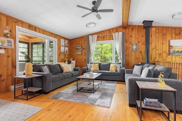 Upper level living room with ample seating, smart tv, wood burning fireplace, boardgames and fabulous views.