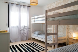 A bunk bed room with a striped rug, a lamp, and a curtain. - Villa Margot, stunning pool, beach 500 m (Agde)