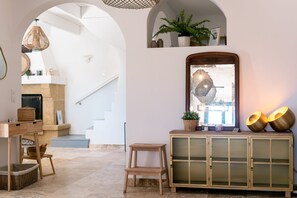 A modern interior with a staircase, a fireplace, a mirror, and a cabinet with decorative lights. - Villa Margot, stunning pool, beach 500 m (Agde)