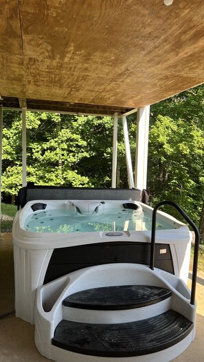 A hot tub under a wooden pergola with a view of green trees. - Beautiful long range views at Tranquility Ridge (Blue Ridge)