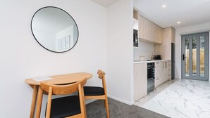 A modern kitchen with wooden cabinets and a built-in oven. - 1 Bed Central City Fringe Deluxe w/Carpark (Christchurch)