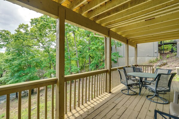 Enjoy dining al fresco on the deck with a scenic view of the surrounding landscape and tranquil body of water.