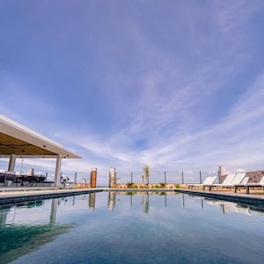 Outdoor pool, open 11:00 AM to 6:30 PM, pool umbrellas, pool loungers