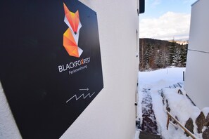 A sign with the Blackfoxrest logo and text indicating it's a serviced apartment.