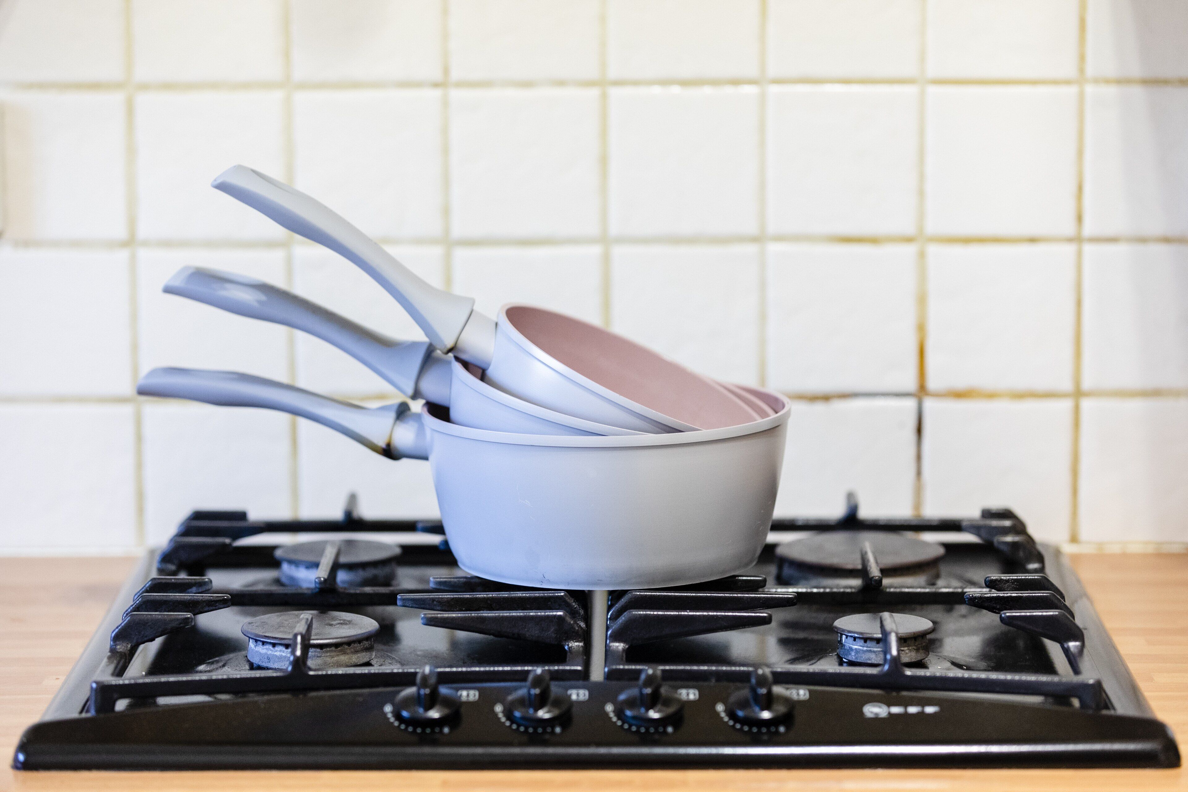 A gas stove with pots and pans on it.