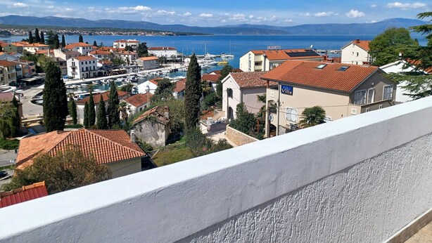 A coastal town with traditional architecture, a marina, and a view of the sea.