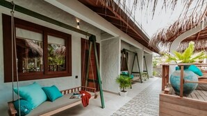 A covered outdoor seating area with swings and potted plants. - Island Luxury Boutique Hotel - Fulhadhoo (Fulhadhoo)