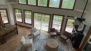 A spacious loft with high ceilings, large windows, and a cozy seating area.