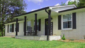 A single-story house with a porch, a welcome sign, and a small garden area. - Gainesboro, TN House, Dale Hollow Lake, Standing Stone State Park, Roaring River (Gainesboro)