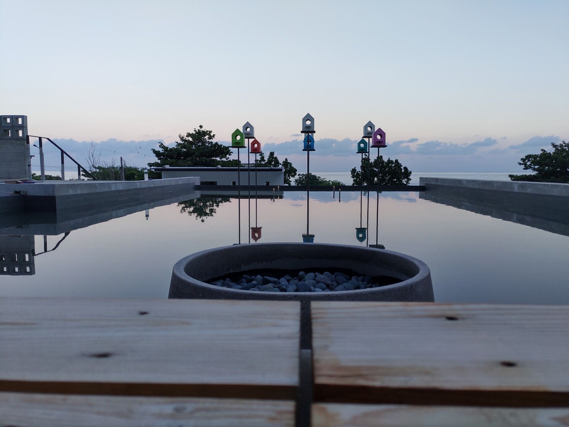 A serene infinity pool with a clear view of the mountains in the background.