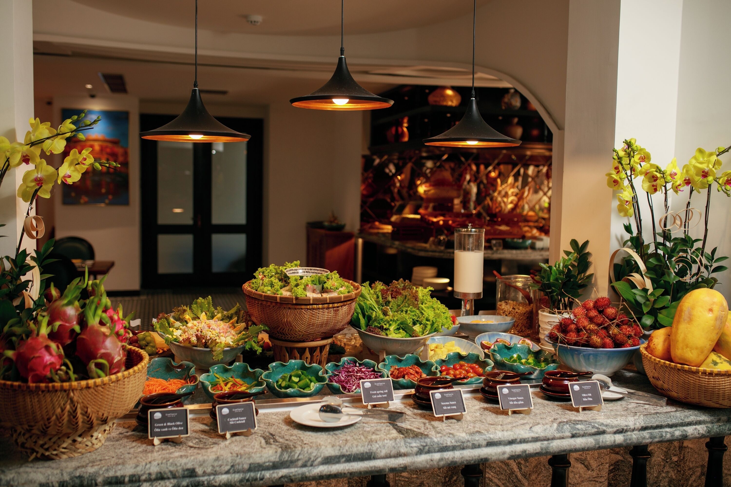 A buffet table with various food items and a sign indicating a gluten-free section.