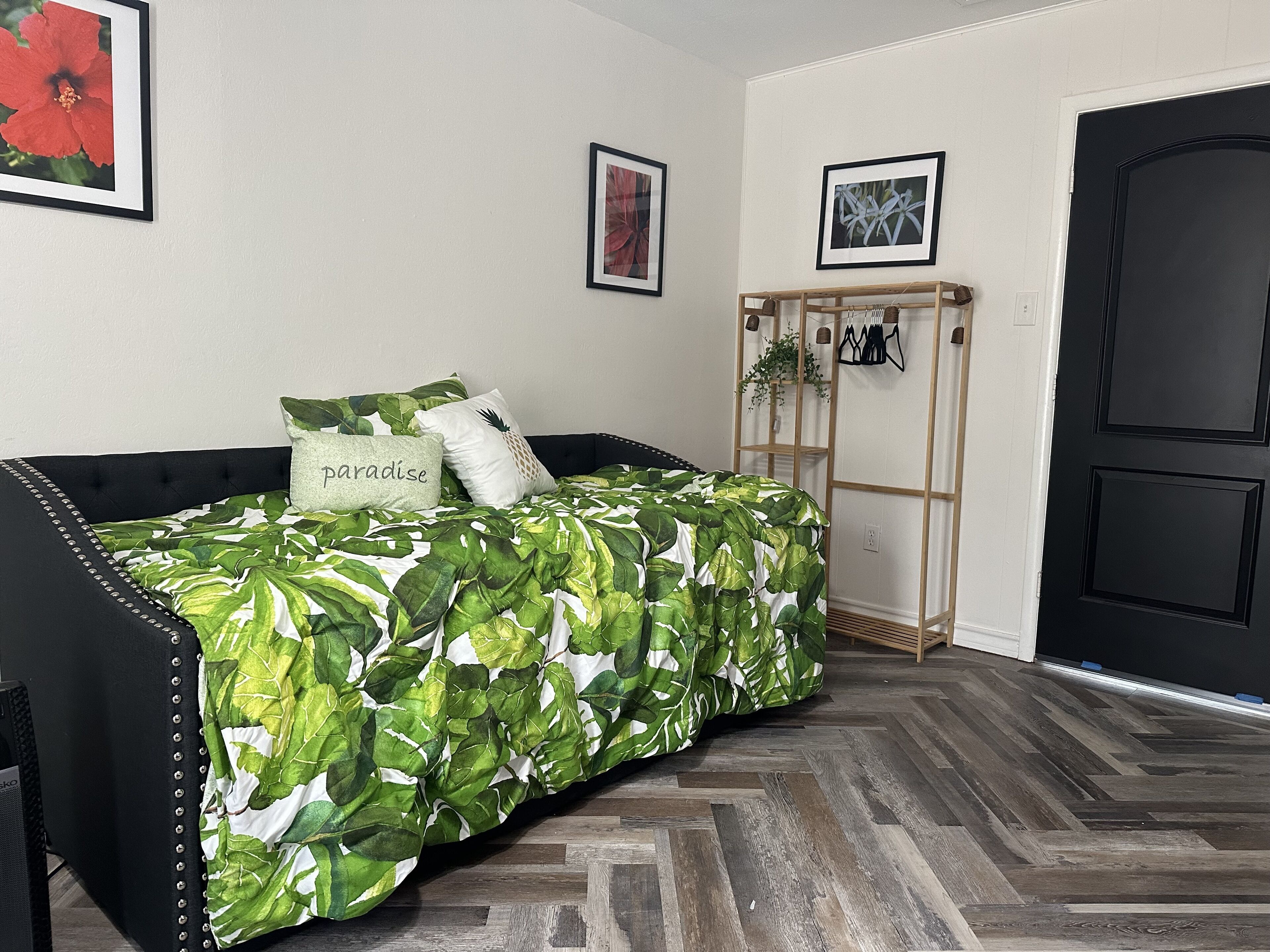 A bedroom with a bed, a wardrobe, and a door.