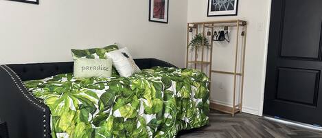 A bedroom with a bed, a wardrobe, and a door.