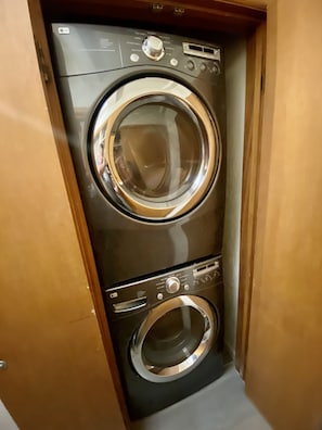 A compact, wall-mounted washer and dryer unit with a control panel and a digital display.