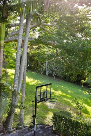 Enjoy a tranquil atmosphere surrounded by lush greenery and a basketball court.