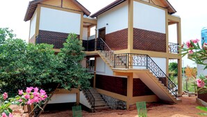 A two-story building with a staircase and a balcony. - Woody Crest Hotel (Trincomalee)