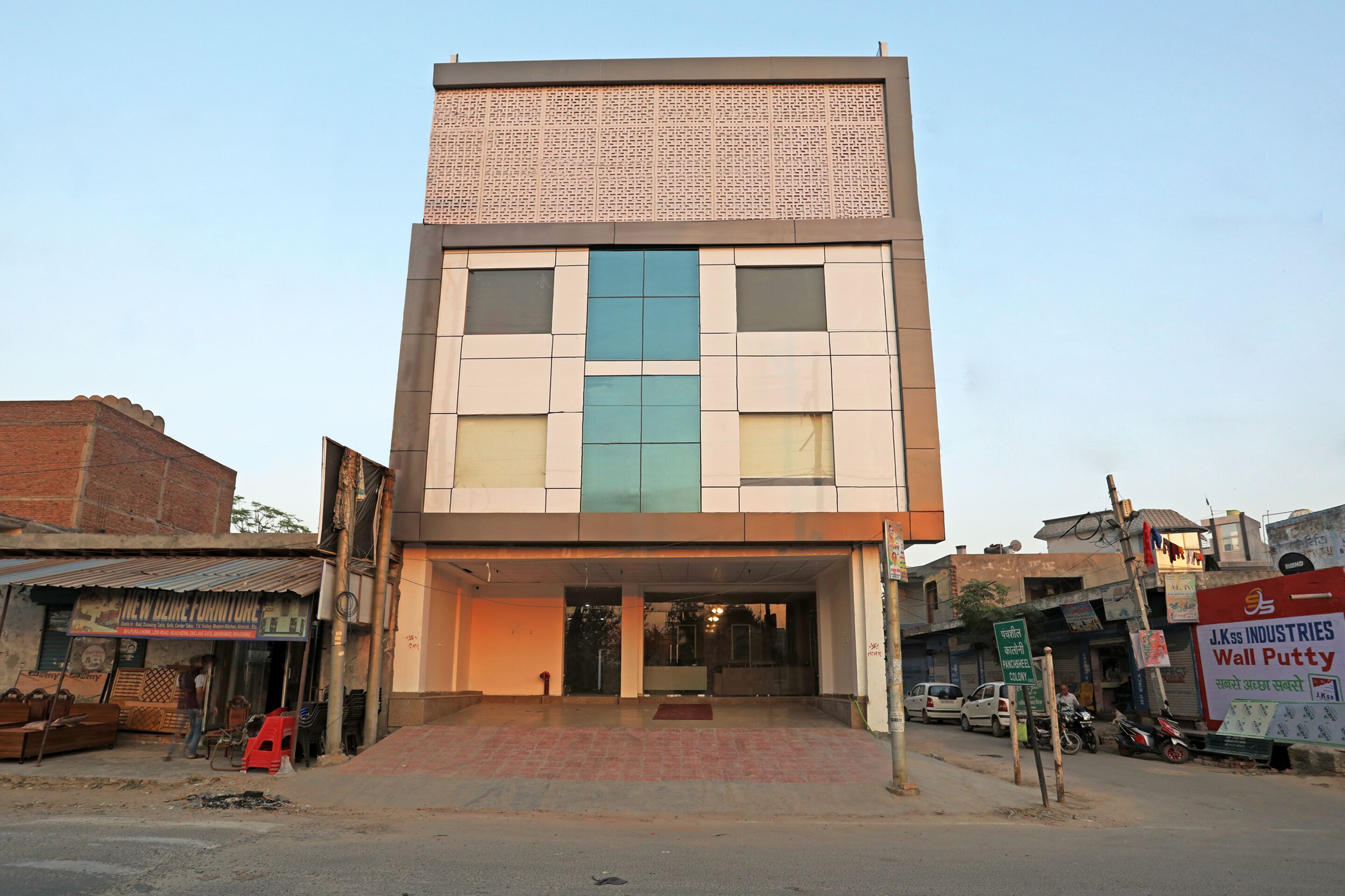 A two-story building with a flat facade, large windows, and a visible entrance.