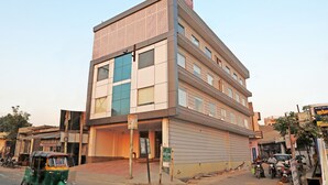 A multi-story building with a flat facade, large windows, and a signboard on the top. - Hotel Fortune Stay (Ghaziabad)