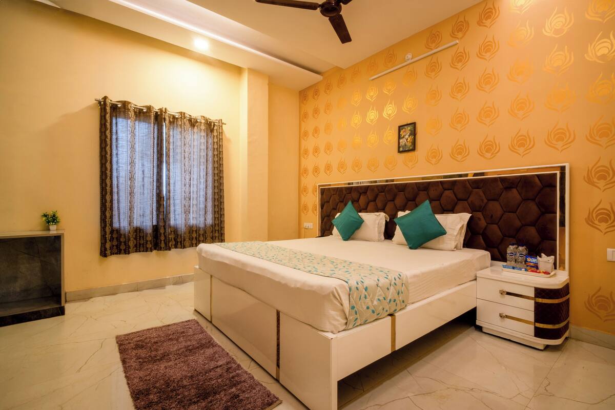 A bedroom with a bed, nightstand, and a ceiling fan.