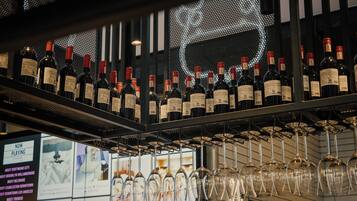A wine rack with bottles and glasses.