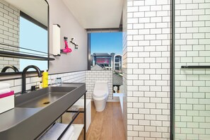 A modern bathroom with a large mirror, a sink, and a toilet. - Moxy Xi'an Downtown (Xi'an)