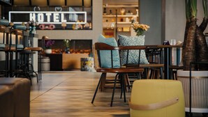 A modern hotel lobby with a neon 'HOTEL' sign, wooden furniture, and a variety of decorative items. - Moxy Xi'an Downtown (Xi'an)