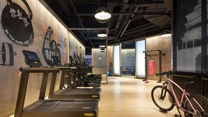 A gym with treadmills, a stationary bike, and exercise equipment. - Moxy Xi'an Downtown (Xi'an)