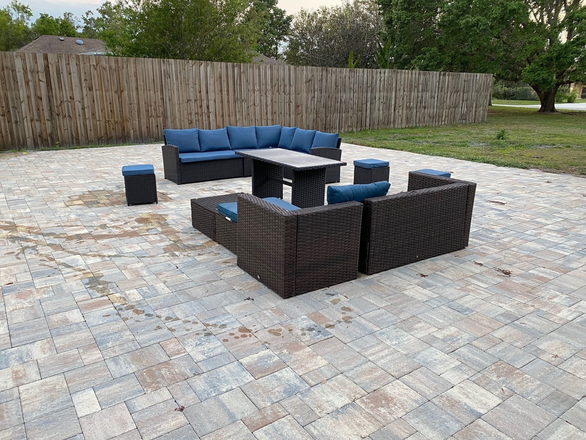 A patio area with a sectional sofa, a coffee table, and two side tables.