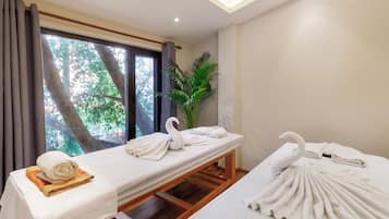Relax in a serene space with a large bed, potted plant, and natural light pouring in through the window.