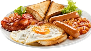 A plate of breakfast food including toast, bacon, eggs, sausages, and baked beans. - Hotel Buddha's Abode- Best Hotel in McleodGanj Main Market (Dharamshala)